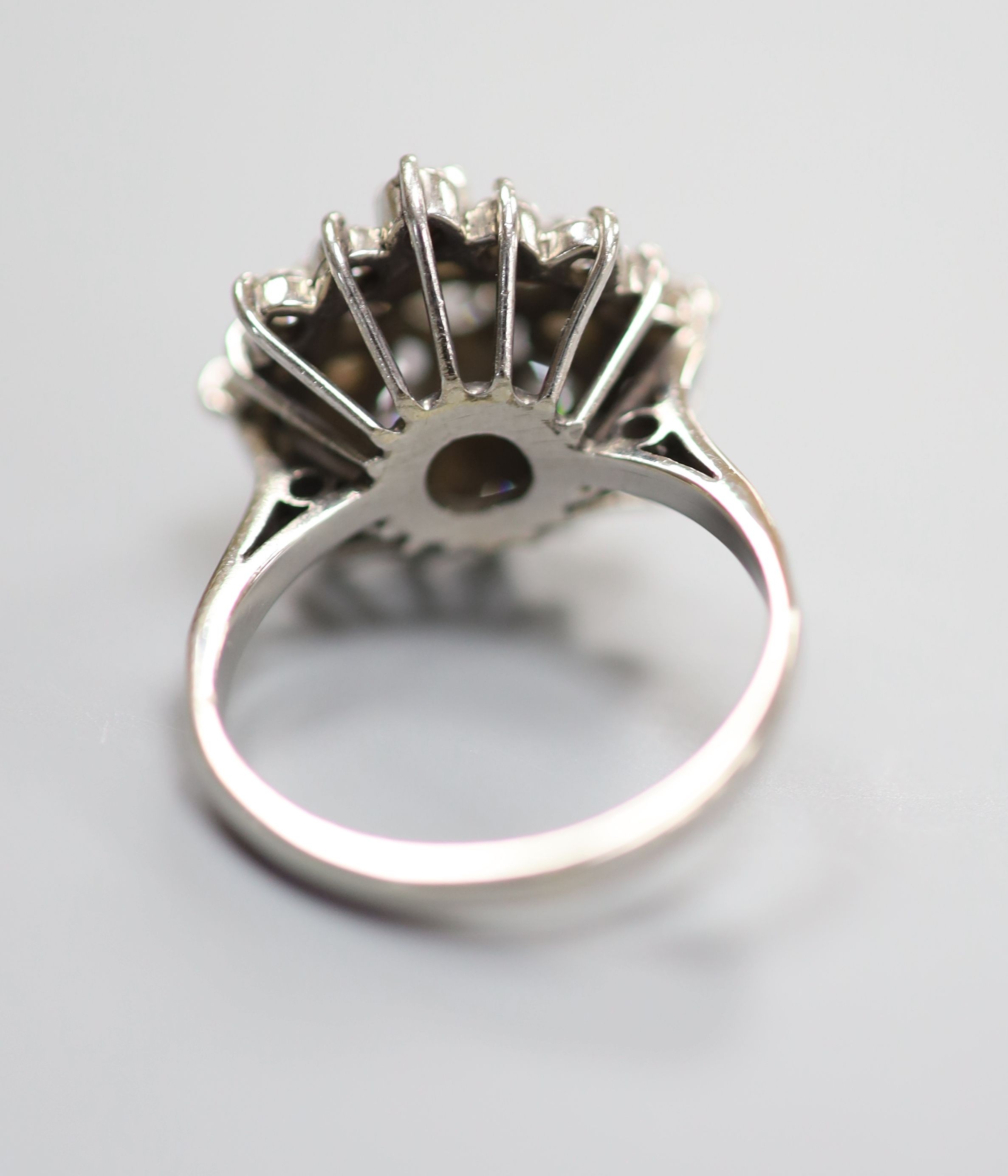 A modern 18ct white gold and diamond set flower head cluster ring, size M, gross weight 6.6 grams.